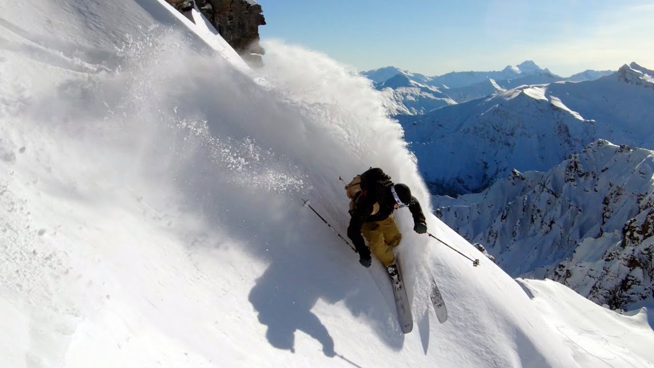 Pro Skier Chris Benchetler slashes through snow in New Zealand Mountains.