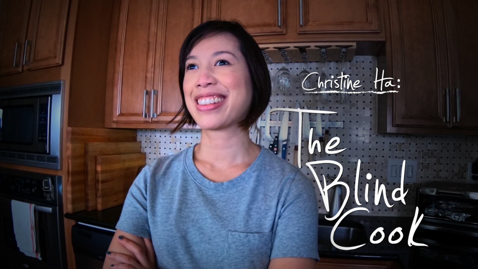 A profile shot of Christine Ha, Master Chef winner with a smile on her face.